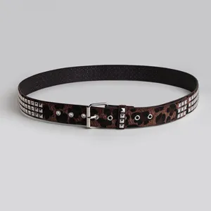 Close-up detail of a stylish women's leopard print belt featuring square metal studs and buckle.