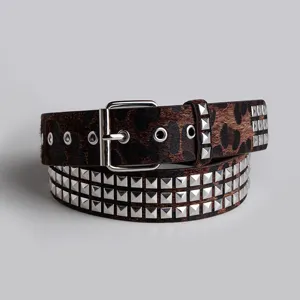 Close-up view of a chic leopard print studded belt with silver hardware and metal buckles.