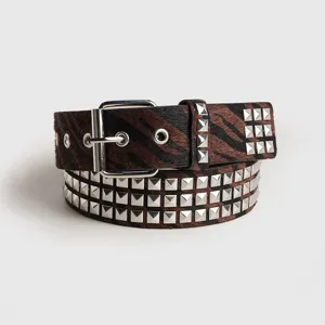 Brown zebra print hair-on-hide belt with silver square studs and metal pin buckle detail.