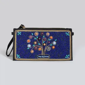 Bohemian beaded PU leather clutch bag detail showing intricate tree embroidery and gold chain trim.