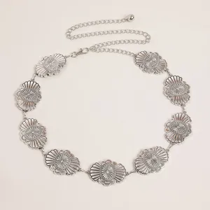 Detailed view of vintage Western style metal waist chain with floral conchos for women fashion.