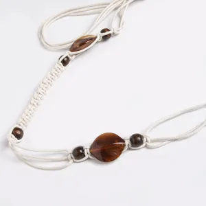 Bohemian woven waist belt for women with wooden beads and ethnic rope design for vacation.