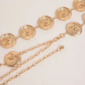 Detailed close-up of retro gold-colored metal waist chain featuring ornate floral links.