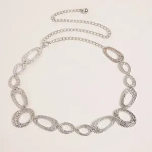 Detailed close-up of retro silver metal chain belt featuring textured oval links and tail.