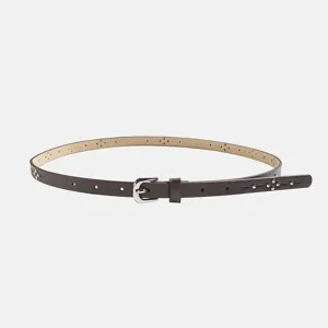 Detailed shot of a women's thin brown faux leather belt with metal rivets and hollows.