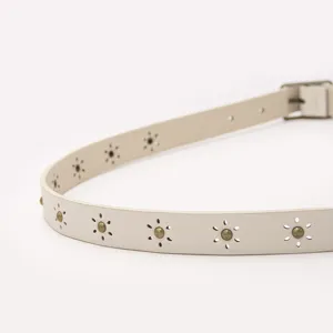 Women minimalist faux leather belt featuring delicate floral cutouts and metal studs.