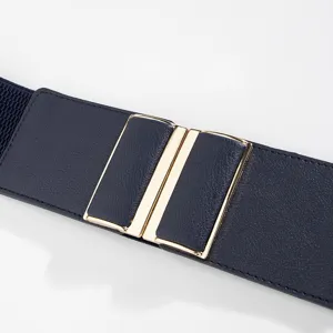 Detailed view of women's wide elastic waist belt with metal interlocking buckle in navy blue.
