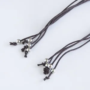 Bohemian braided waist rope detail with silver metallic beads for summer vacation.
