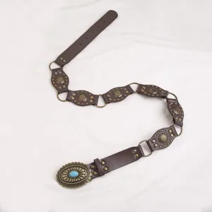 Western style vintage brown leather belt with carved metal links and turquoise stone buckle detail.
