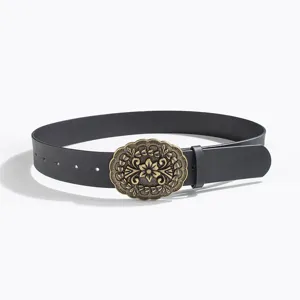 Close-up detail of vintage western retro carved metal buckle black women leather belt