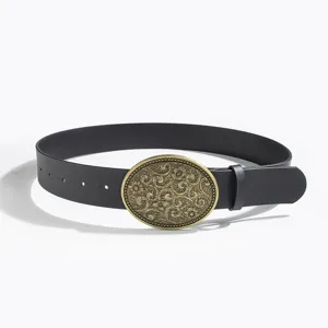 Vintage western style carved oval metal buckle black leather belt detail shot for women