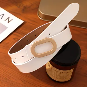 Minimalist white leather belt with gold oval buckle, elegant accessory for women's fashion outfits.
