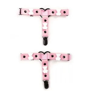Detail shot of cute pink leather garter leg ring with white bear charms and adjustable straps.