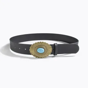 Detail view of a western style vintage black leather belt featuring an ornate bronze buckle.