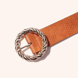 Close-up of stylish brown snake pattern PU leather belt featuring twisted round gold buckle.