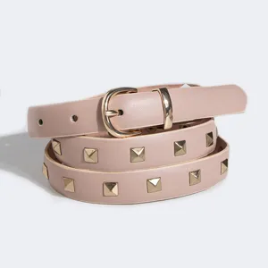 Close-up of pink leather belt with gold pyramid studs and buckle, stylish accessory.