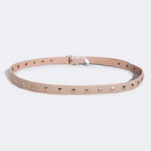 Pink thin leather belt featuring stylish gold-tone pyramid studs and classic metal buckle.