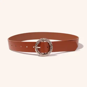 Detailed view of brown PU leather women's belt featuring stylish twisted round metal buckle.