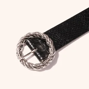 Black snake print PU leather belt with twisted round metal buckle, closeup detail shot.