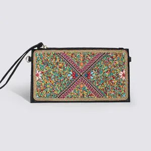 Detailed shot of bohemian style colorful beaded clutch bag, ethnic geometric pattern detail.