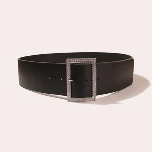 Close-up of the elegant black wide belt featuring a dazzling crystal rhinestone rectangular buckle detail.