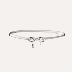 Detailed view of the elegant silver metallic bow waist chain, stylish women accessory item.