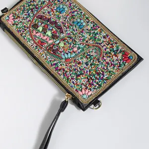 Bohemian colorful beaded clutch detail, exquisite ethnic handbag craftsmanship and gold zipper.