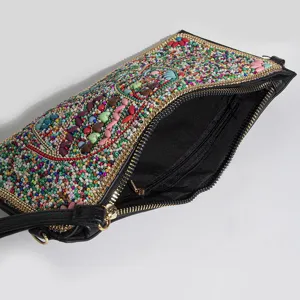 Bohemian beaded detail view of black PU leather crossbody handbag with colorful floral patterns.