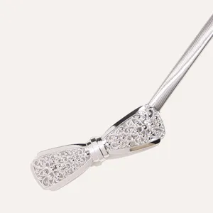 Close-up of the exquisite silver metal bow detail on the elegant elastic waist belt.