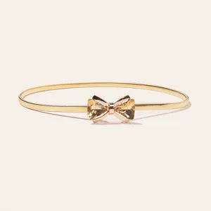 Detailed close-up view of women's gold spring waist chain with sparkling rhinestone bow.