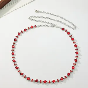 Elegant silver-tone chain belt featuring sparkling red crystal rhinestones for women fashion.