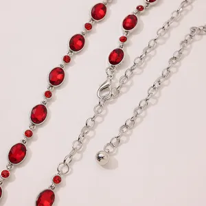 Detailed close-up of a glamorous women silver-tone waist chain featuring sparkling red rhinestones.