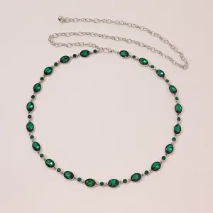 Exquisite women's silver metal chain belt featuring sparkling green oval rhinestones detail.