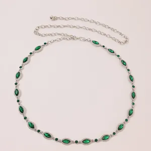 Exquisite silver metal waist chain with sparkling green rhinestones, elegant detail view.