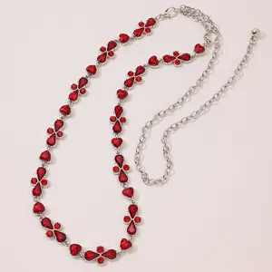 Detailed view of women's silver waist chain featuring vibrant red crystal rhinestone elements.