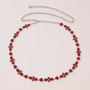Exquisite women waist chain with red rhinestones and silver metal links for fashion outfits.