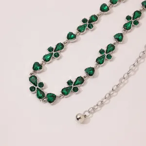 Exquisite green rhinestone waist chain detail featuring elegant crystal clover and heart charms.