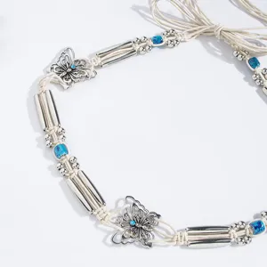 Detailed view of bohemian braided waist belt with silver butterfly charms and blue beads.