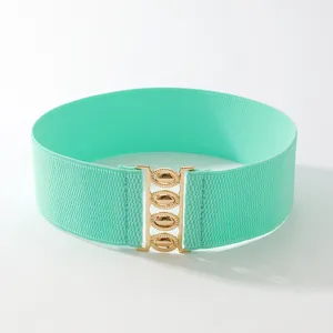 Women's mint green wide elastic waist belt with gold interlocking metal buckle for dress