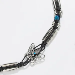 Close-up detail of bohemian butterfly silver bead braided rope belt showcasing intricate metal work.