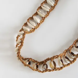 Handmade bohemian natural shell woven waist rope detail showing intricate craftsmanship.