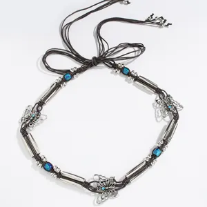 Detail shot of boho braided waist belt with silver butterfly charms and blue beads.