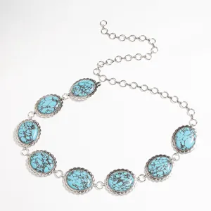 Detailansicht eines vintage Damen Taillengürtels mit Türkis Steinen und filigranen Metallgliedern.