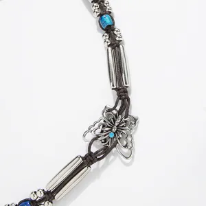 Bohemian braided waist belt detail with silver beads, blue stones and butterfly metal charm.