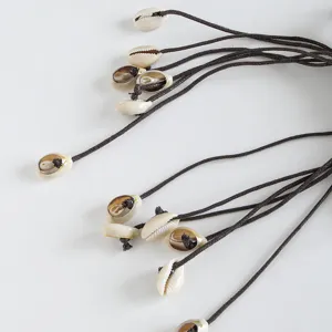 Handcrafted bohemian cowrie shell waist chain detail, stylish beach belt for women.