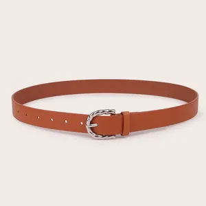 Detailed shot of a brown women PU leather belt featuring a silver twisted metal buckle.