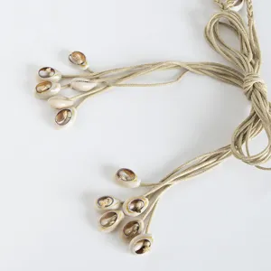 Handmade bohemian cowrie shell braided waist belt for women, natural summer beach style.