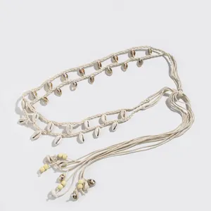 Bohemian woven waist belt for women with natural shells and beads, stylish summer accessory.