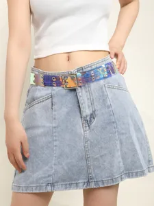 Close-up detail shot of the transparent holographic PVC double-grommet belt with double buckle.