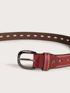 Close up view of women leather belt buckle detail with hollow pattern and white stitching.